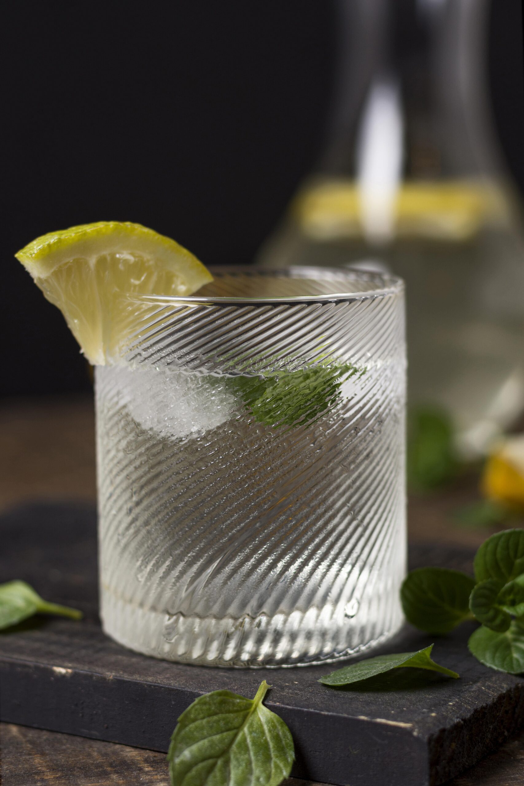Gin and tonic in frosty glass with lemon wedge