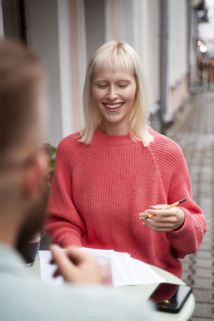 woman smiling across from man going through paperwork